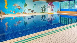 An indoor swimming pool with a mural of marine life, clear water, and a wooden ceiling. - Tranquil Ewijk Escape for 6 (Ewijk)