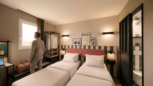 A hotel room with two beds, a desk with a laptop, a hanging coat rack, and artwork on the wall. - Hôtel EH OH Orly Rungis (Rungis)