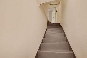 A narrow staircase with a handrail, leading to a door at the top. - A Beaming 3-BR/2Ba - Montorgueil (Paris)