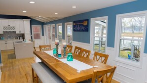 A dining area with a wooden table, chairs, and a bench.