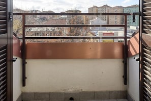 A view from a balcony with a metal railing, a sign for 'BOWLING SPACE,' and a building labeled 'ACCAPLANET' in the background. - NOVARA, 6 - In the attic with style (Milan)