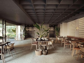 A modern restaurant interior with wooden furniture, a central dining table, and a view of the outdoors. - Nirema Hotel & Spa Samos - Mgallery Collection (Samos)