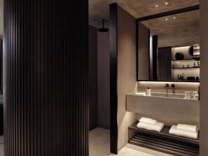 A modern bathroom with a large mirror, a built-in sink, and a towel rack. - Nirema Hotel & Spa Samos - Mgallery Collection (Samos)
