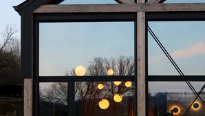 A modern building with large windows and a wooden structure. - Modern Design House With Sauna 'arduenna Silva' (La Roche-en-Ardenne)