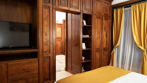 A room with a bed, wooden wardrobe, and a television. - Apartament 8 (Timișoara)