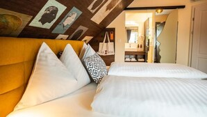 A hotel room with a bed, a yellow headboard, and a ceiling with artwork. - Hotel Gut Sein  (Sankt Georgen im Lavanttal)