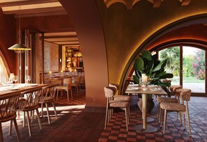 A restaurant with a checkered floor, wooden furniture, and a view of greenery outside. - CASA METT Sitges - Newly refurbished (Sitges)