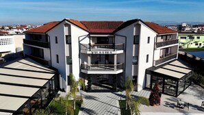 A modern building with a central entrance, balconies, and a sign reading 'VILALIRA'. - Vila Lira (Durres)