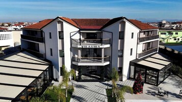 A modern building with a central entrance, balconies, and a sign reading 'VILALIRA'.