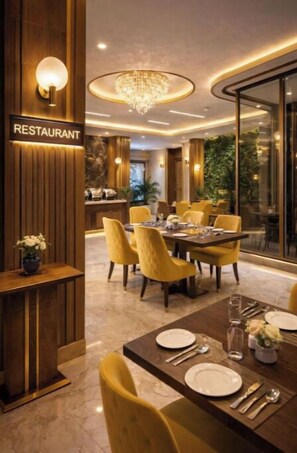 A restaurant interior with a wooden reception desk, a chandelier, yellow chairs, and a dining table set for four. - Hotel Urban Lion - Delhi Airport (New Delhi)