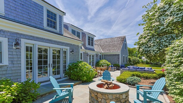 A house with a patio, outdoor seating, and a stone fire pit. - Walk to Famous Chatham Lighthouse Beach (Chatham)
