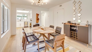 A modern kitchen with a round dining table, chairs, and a built-in oven. - Patio & Pool Access! Mtn-view Palm Springs Escape (Palm Springs)