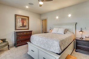 A bedroom with a bed, dresser, nightstand, lamp, and a framed picture on the wall. - Hike, Golf & Unwind! Mtn-view Cedar City Townhome (Cedar City)