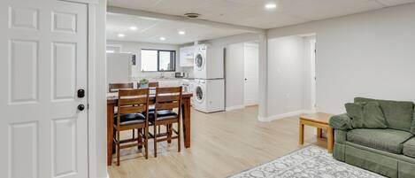 A modern apartment with a dining area, kitchen, and living room.