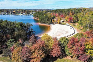 A lake with a beach and surrounding trees. - Boat & Relax on Smith Mountain Lake! Bright Condo (Moneta)