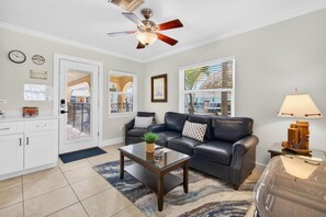 A living room with a sofa, coffee table, and a ceiling fan. - Coconut Villa`s - Suite 10 (Redington Shores)