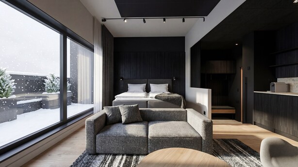 A modern bedroom with a large window, a bed, a sofa, and a kitchen area. - Santa's Hotel Noelle (Rovaniemi)
