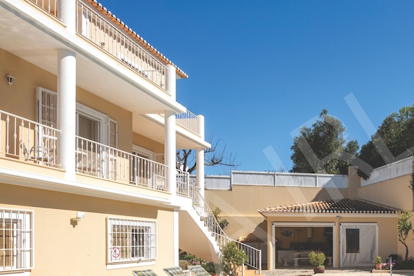 View of the rear of Villa Irlandais, showing multi-level balconies, terraces and outdoor living spaces.