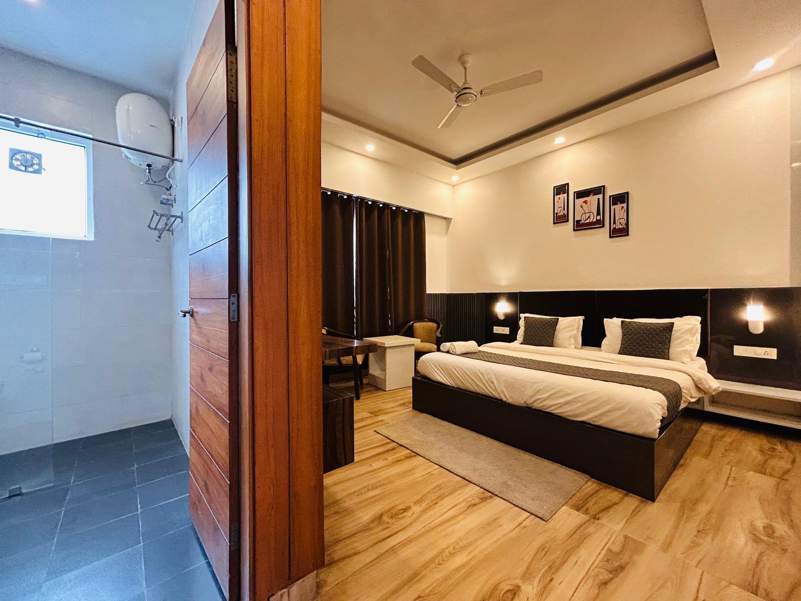 A bedroom with a bed, bedside tables, a ceiling fan, and a window with curtains.