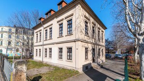A multi-story building with a classical architectural style, featuring a symmetrical facade, large windows, and a prominent entrance. - Vita Aurum Elbe-Apartments Neustadt  (Dresden)
