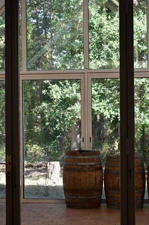 A room with large windows, wooden barrels, and a view of trees. - Private estate for 35 people • Lake Rillé (37) • Nature, Space, Community   (Rillé)