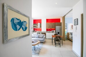 Settle into your modern open-plan space where bold red kitchen accents meet contemporary comfort, perfect for cooking and relaxing. - Pool, Gym & Balcony | Perfect Romantic Zone Stay (Puerto Vallarta)