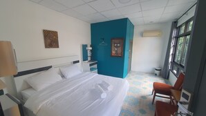 A hotel room with a bed, a desk, a chair, a window, and a bathroom. - Room-charming Boutique Guest Retreat in (Chiang Mai)