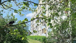 A residential building with multiple balconies, surrounded by greenery and trees. - Holiday Apartment for 2 People, Swinoujscie (Swinoujscie)