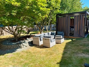 A patio area with outdoor furniture and a covered structure.