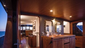 A wooden deck with a wooden cabin and a large mirror.