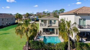 A residential property with a swimming pool, multiple-story houses, and a well-maintained lawn. - Epic Playhouse Getaway - Castle & Superhero Bunks, Theater, Private Pool, No Rear Neighbors (Four Corners)