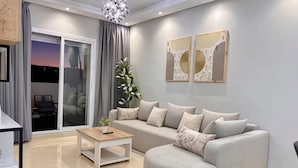 Una sala de estar moderna con un sofá, una mesa de centro y una planta en maceta.