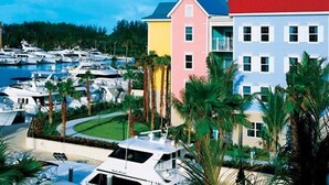 A marina with multiple boats, colorful buildings, and palm trees. - Harborside Resort at Atlantis-2 Bedrooms and Full Resort Access (N.P)