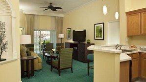 A hotel room with a living area, a dining area, a kitchen, and a balcony. - Harborside Resort at Atlantis-2 Bedrooms and Full Resort Access (N.P)