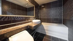 A modern bathroom with a zebra-patterned wall, a large mirror, a sink, and a bathtub. - Incheon Business Hotel Myung-Jak (Incheon)