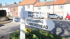 A directional signpost with destinations like Bampton, Filey, and N & S Landing. - Puffin's Nest (Bridlington)