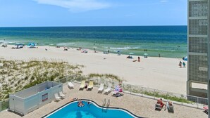A pool area with a view of the beach and ocean. - Beachfront Studio w/ Pool, Steps to Sand, Sleeps 3 (Panama City Beach)