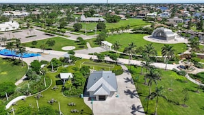 An aerial view of a park with a large building, pathways, and greenery. - Sea Winds 1404 (Marco Island)