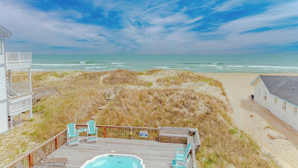 A beach house with a deck, outdoor seating, and a view of the ocean. - JL #261 | The Beach House | Oceanfront | Ocean Views (South Nags Head)