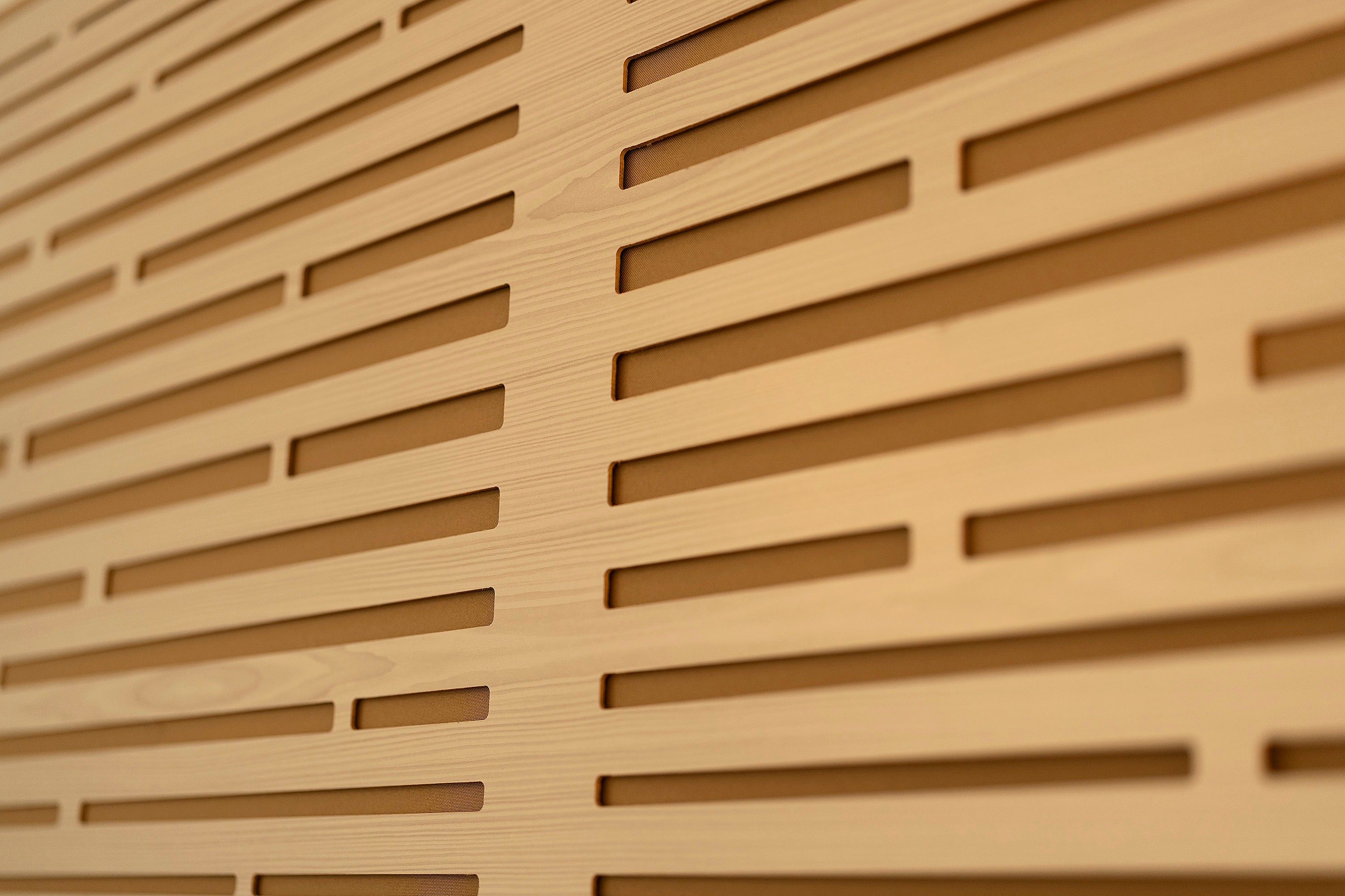 A close-up of a wooden slatted wall with a uniform pattern.