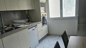 A kitchen with a dishwasher, a microwave, and a window. - Chambre Lit double (Dunkirk)
