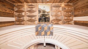 A wooden sauna with a central bench, geometric wall patterns, and a framed picture. - BEIM LOIS Dorfblick – 2 Floors & Sauna Access (Gerlos)