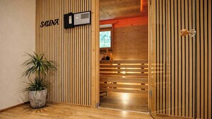 A wooden interior with a sign reading 'SAUNA' and a potted plant. - HOCHEBEN – Balcony & Private Sauna (Ramsau im Zillertal)