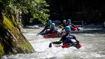 A group of people kayaking on a river.