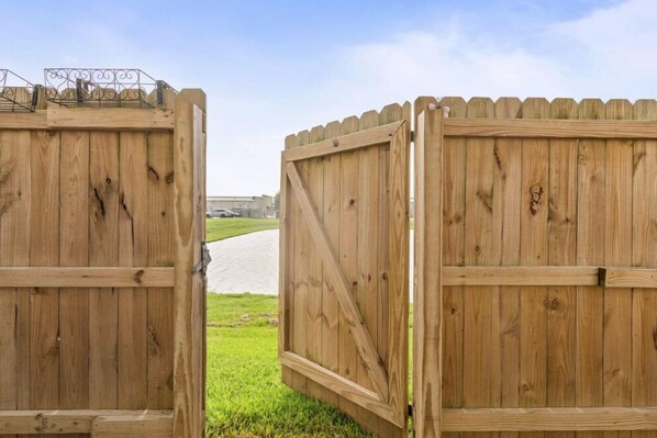 A wooden gate with a metal gate latch.