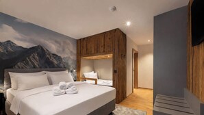 Ein modernes Schlafzimmer mit einem großen Bett, Holzvertäfelung und einer Bergwandmalerei.