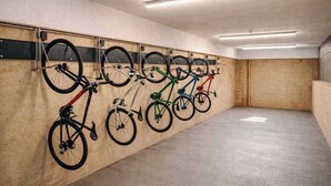 A bike storage area with multiple bicycles mounted on a wall. - CHEZ NOUS – Balcony & Mountain View (Fügen)