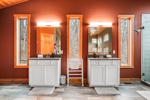 A bathroom with two sinks, wooden cabinets, and large mirrors. - Starr & Sky Lodge | Hocking Hills, Hot Tub, Sauna (Logan)