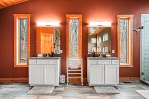 A bathroom with two sinks, wooden cabinets, and large mirrors. - Starr & Sky Lodge | Hocking Hills, Hot Tub, Sauna (Logan)