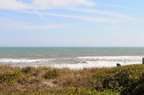 A coastal landscape with waves, vegetation, and a clear sky. - Southern Aire - a spacious 5-bedroom oceanfront in Surf City, NC (Surf City)